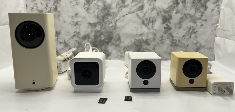 Four (4) WYZE CAM WHITE Cameras with 2 Memory Cards & cables All for parts.