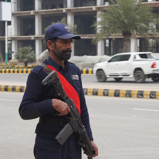 Veteran Security & Protection (Pvt) Ltd security guard with handling foreign made gun performing security duty outside a client's premises