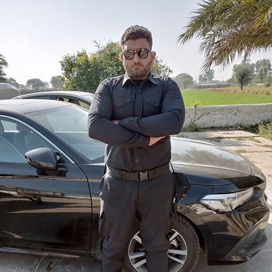 Security officer standing in front of a client's vehicle